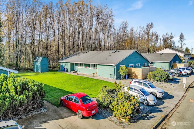 back of property featuring a storage unit and a yard