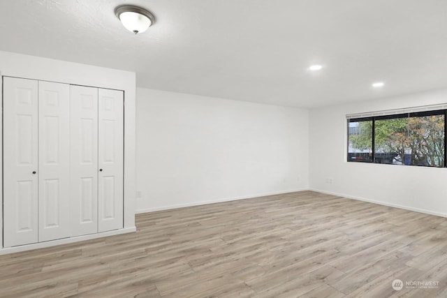 unfurnished bedroom featuring a closet and light hardwood / wood-style floors