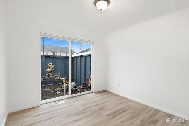 spare room featuring wood-type flooring