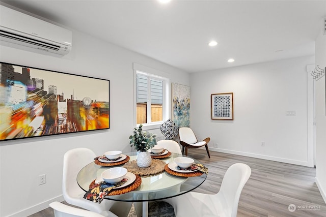 dining area featuring hardwood / wood-style flooring and a wall mounted AC