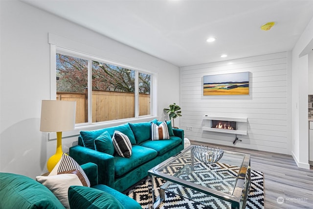 living room with wood-type flooring and a fireplace