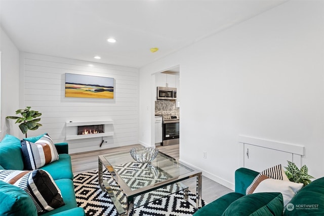 living room with light hardwood / wood-style flooring and a fireplace