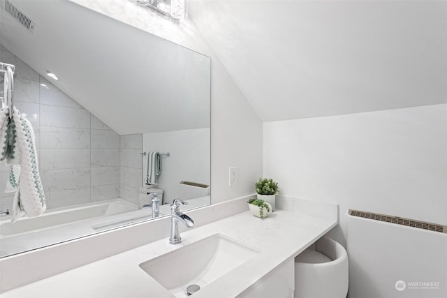 bathroom with lofted ceiling, vanity, radiator, and shower / bathing tub combination