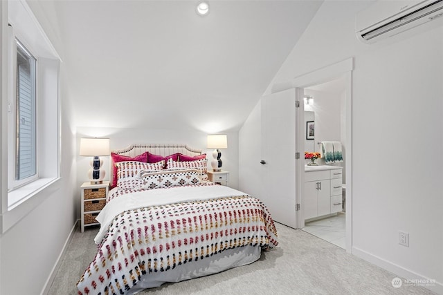 bedroom with light carpet, connected bathroom, and an AC wall unit