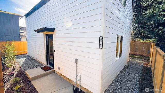 view of side of home featuring a fenced backyard