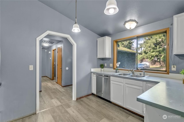 kitchen with sink, hanging light fixtures, stainless steel dishwasher, white cabinets, and light wood-type flooring