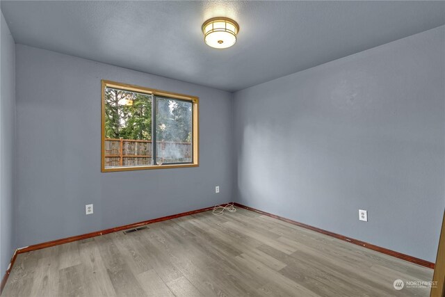 spare room featuring light wood-type flooring