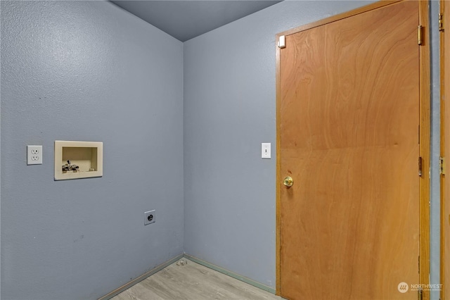 laundry room featuring electric dryer hookup, hookup for a washing machine, and light hardwood / wood-style floors