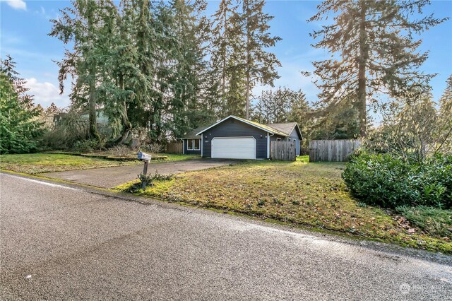 view of front of property with a front lawn and a garage