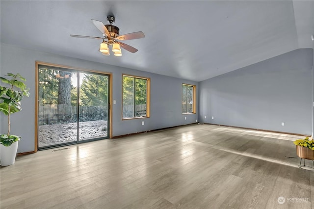 unfurnished living room with ceiling fan, light hardwood / wood-style floors, and lofted ceiling