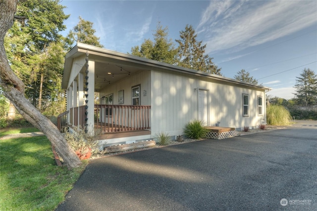 view of property exterior with a porch