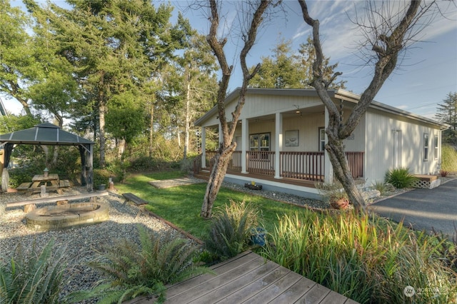 exterior space featuring a fire pit, a porch, and a gazebo