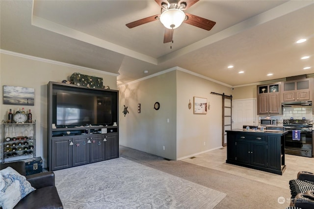 living room featuring ornamental molding, light carpet, a barn door, and a tray ceiling