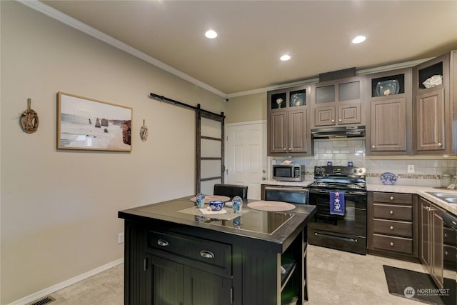 kitchen featuring black / electric stove, a kitchen island, ornamental molding, and a barn door