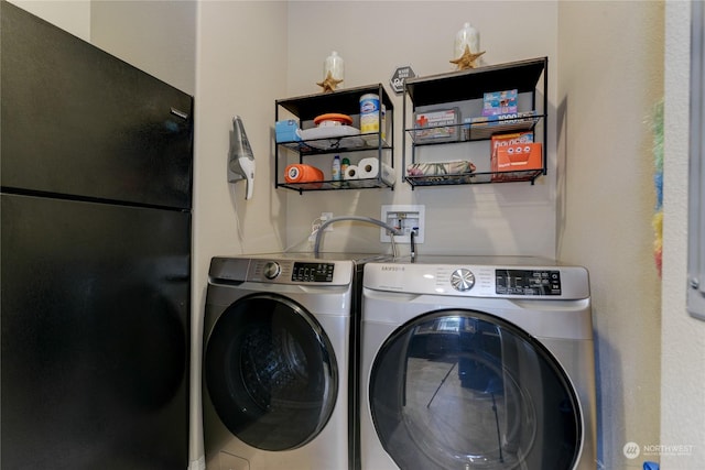 clothes washing area with separate washer and dryer