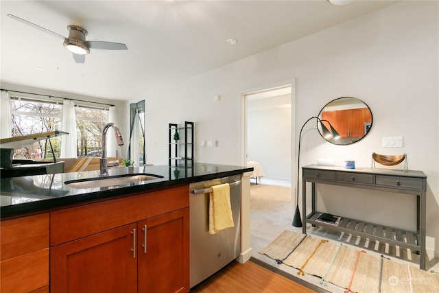 kitchen with light colored carpet, stainless steel dishwasher, ceiling fan, and sink