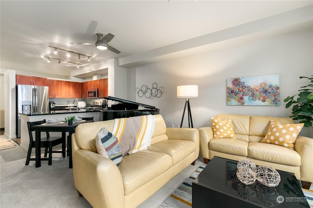 carpeted living room with ceiling fan