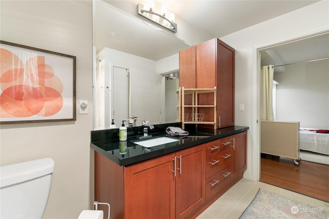 bathroom with tile patterned floors, vanity, and toilet