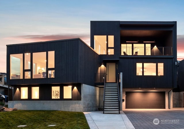 modern home with a balcony and a garage