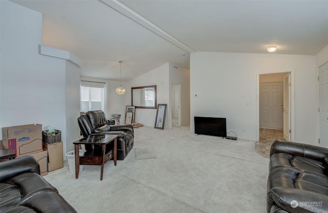 carpeted living room with lofted ceiling with beams and an inviting chandelier