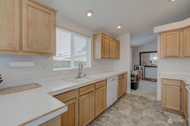 kitchen featuring lofted ceiling, light carpet, white dishwasher, sink, and light brown cabinetry