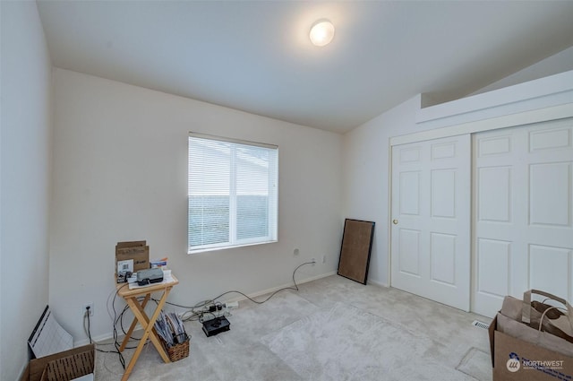 miscellaneous room with light colored carpet and lofted ceiling