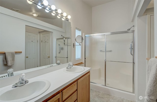 bathroom featuring vanity and an enclosed shower