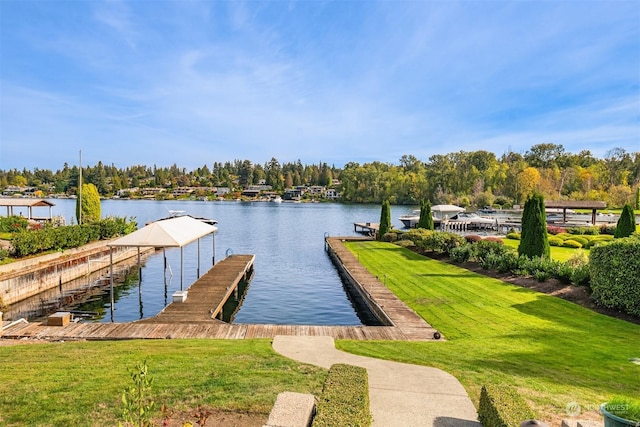 view of dock with a water view and a lawn