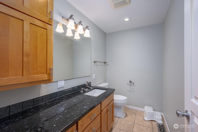 bathroom featuring tile patterned flooring, vanity, and toilet