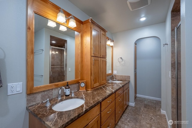 bathroom with vanity and a shower with shower door