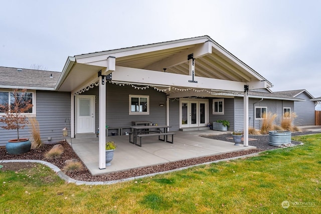 back of house with a lawn, a patio, and french doors