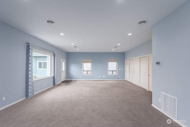 unfurnished room featuring carpet flooring and a wealth of natural light