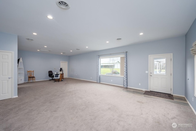 unfurnished living room with light colored carpet