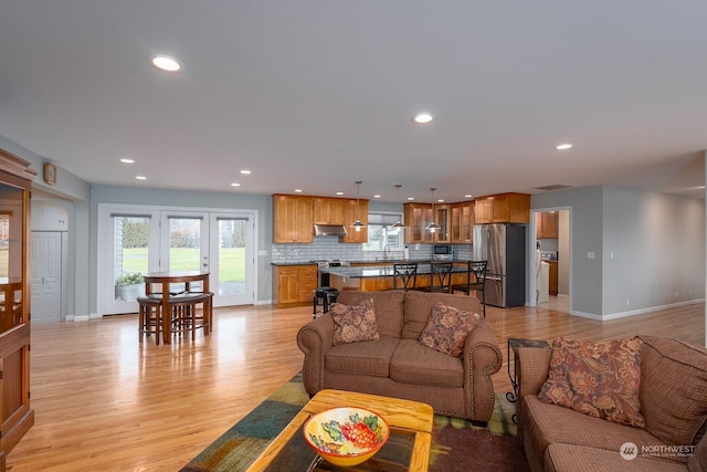 living room featuring sink and light wood-type flooring