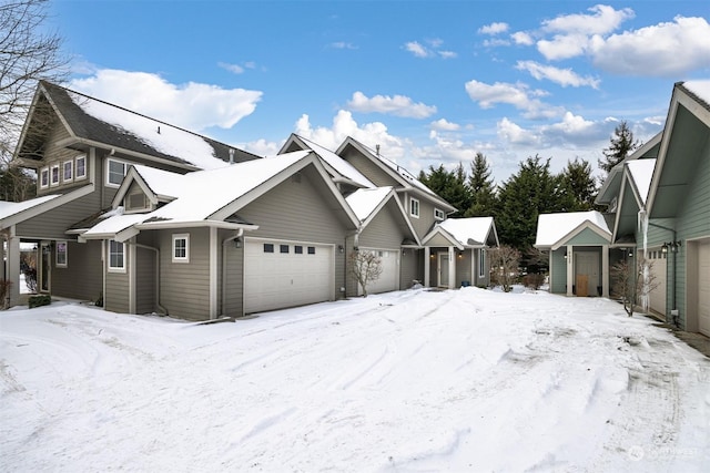 snow covered property featuring a garage