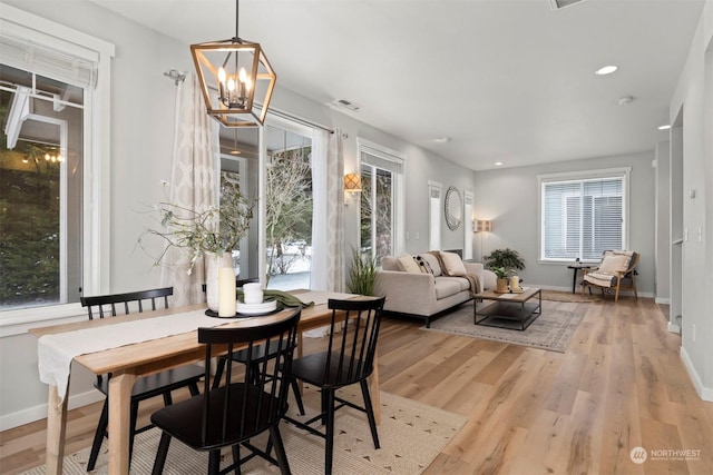 sunroom / solarium with a notable chandelier