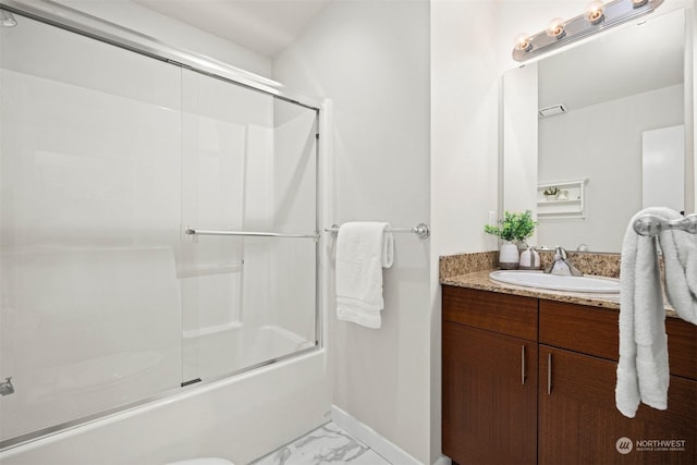 bathroom featuring vanity and combined bath / shower with glass door