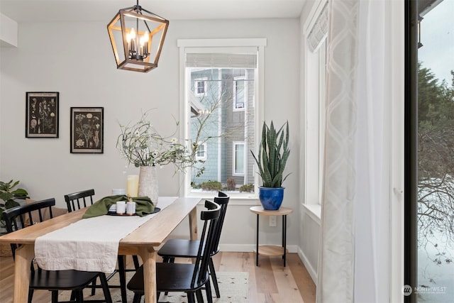 dining area featuring light hardwood / wood-style flooring and a chandelier