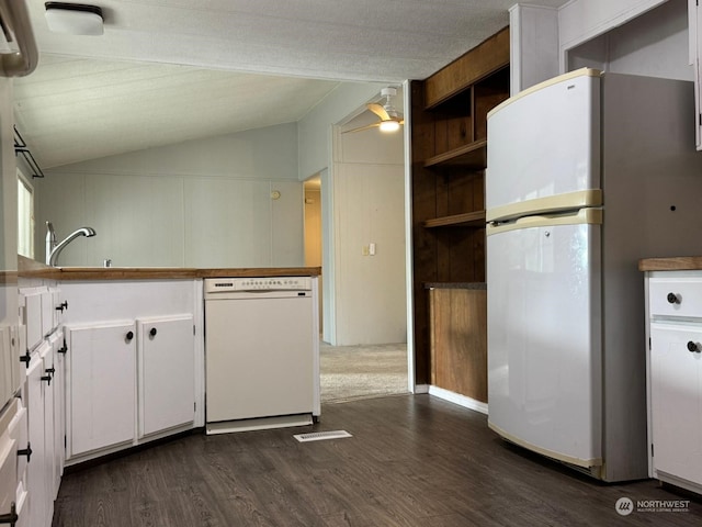 kitchen with white appliances, vaulted ceiling, dark hardwood / wood-style floors, ceiling fan, and white cabinetry