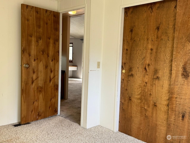 interior space featuring light carpet and a textured ceiling