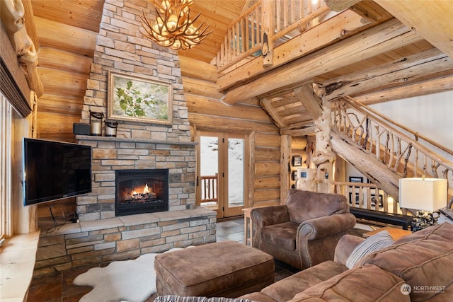 living room featuring a stone fireplace, high vaulted ceiling, log walls, wooden ceiling, and an inviting chandelier