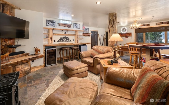 living room featuring wine cooler, indoor bar, and a notable chandelier