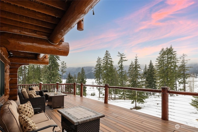 snow covered deck featuring an outdoor living space