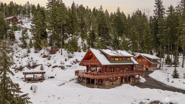 snow covered property with a deck