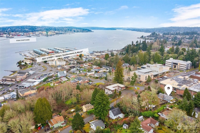 birds eye view of property with a water view