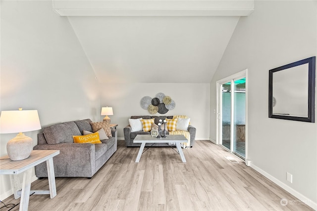 living room with beamed ceiling, light hardwood / wood-style floors, and high vaulted ceiling