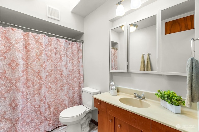 bathroom featuring toilet and vanity