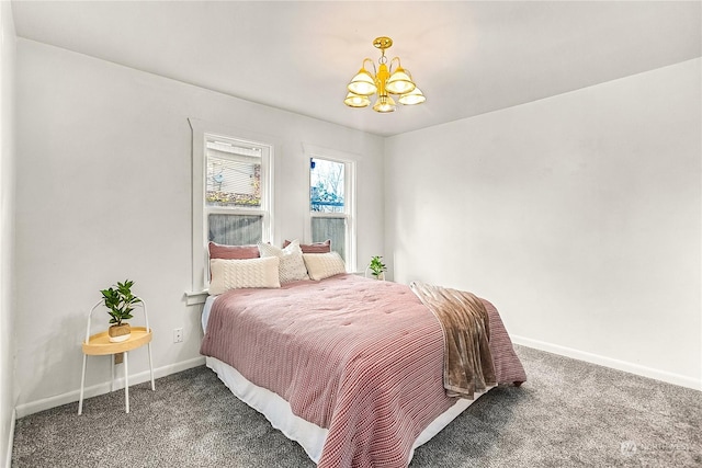 bedroom featuring a chandelier and dark colored carpet