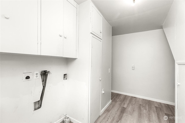 laundry area with cabinets, light hardwood / wood-style floors, hookup for a washing machine, and electric dryer hookup