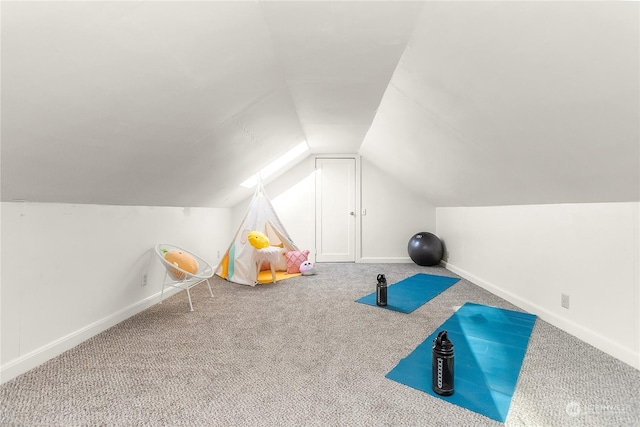 workout room featuring carpet and lofted ceiling